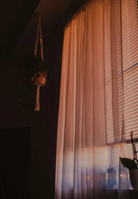 a room with a window and some white curtains