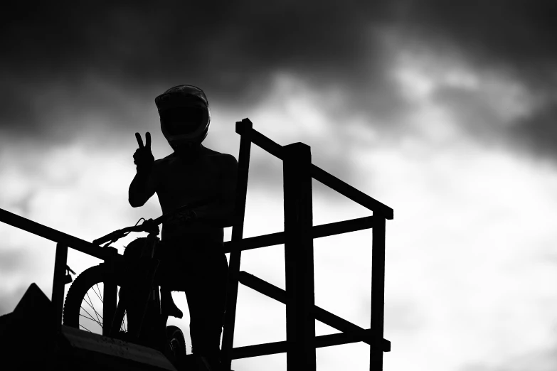 a person standing on the railing near a bike