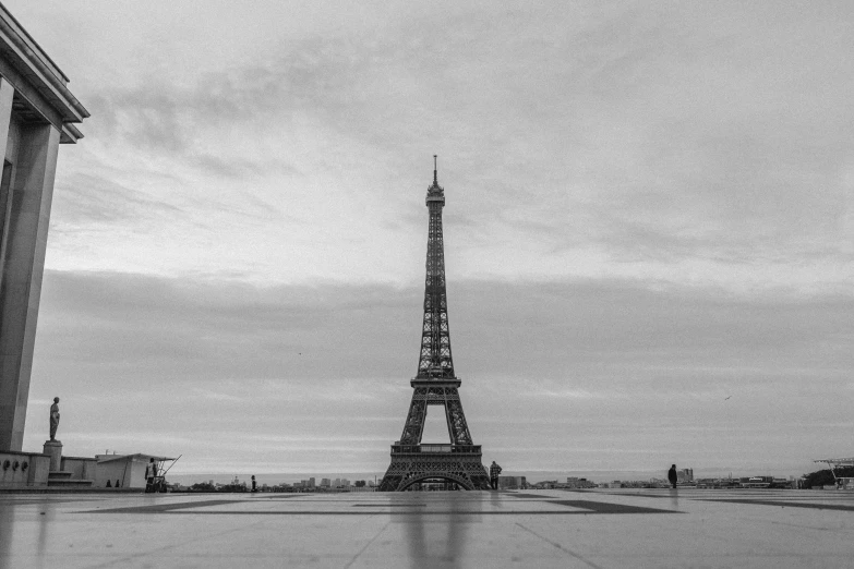 the eiffel tower stands tall in front of a large stone building