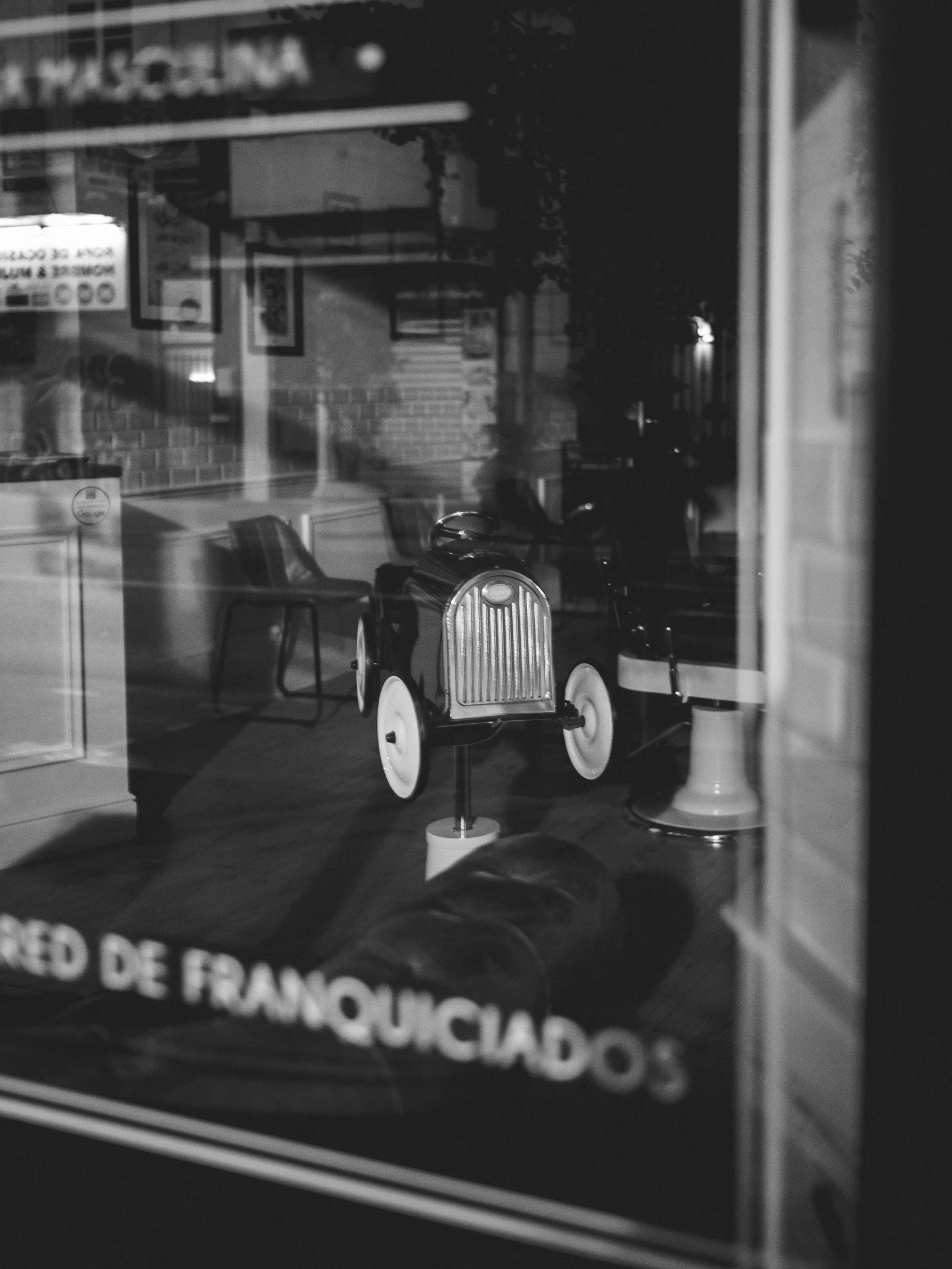 an old model car on display in a store window