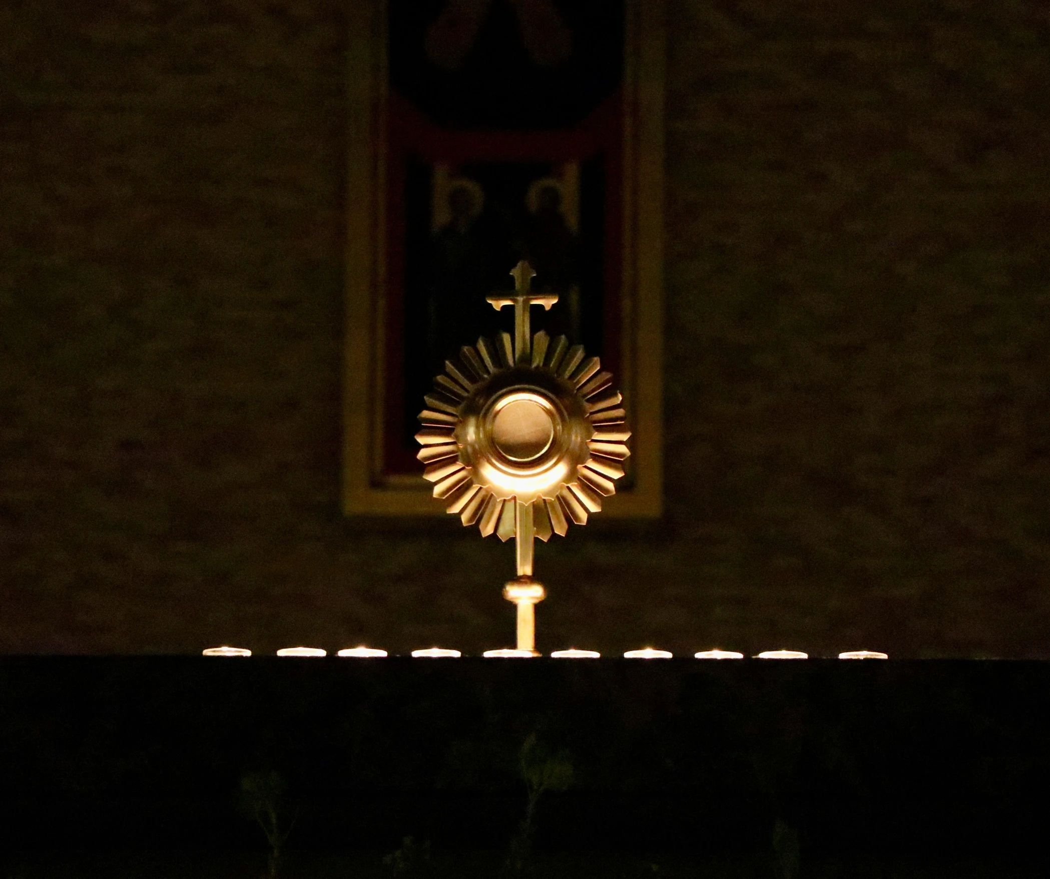 a clock in the center of a window at night