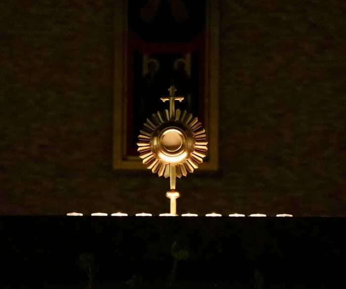 a clock in the center of a window at night