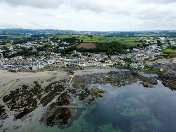 a small town near a body of water with lots of buildings on the shore