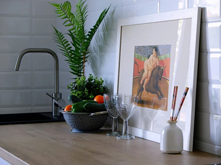 a table filled with various fruit and two paintings