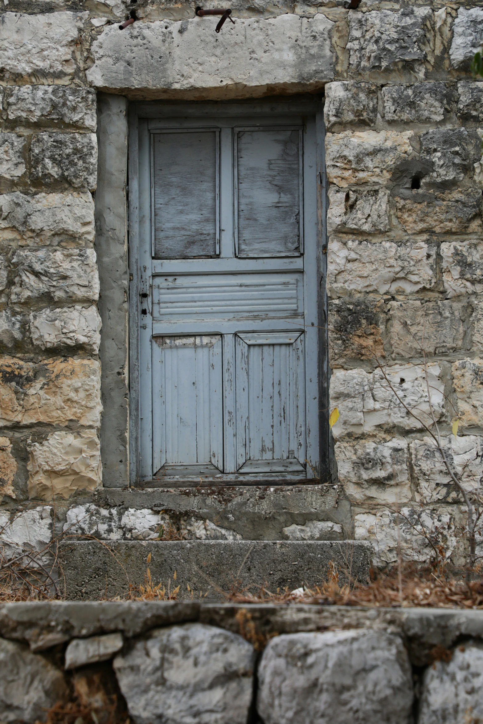 a wooden door on top of stone walls