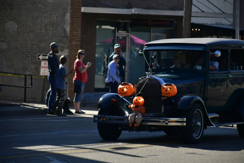 a car with halloween pumpkins on it's windows in a street