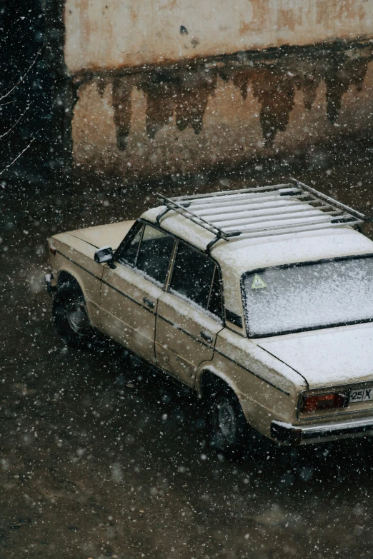 the old car is covered in snow with its roof partially up