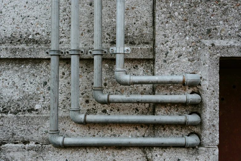 a large group of pipes on the side of a building