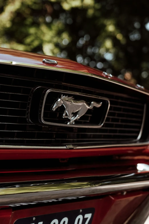 a red mustang logo is shown on a mustang emblem