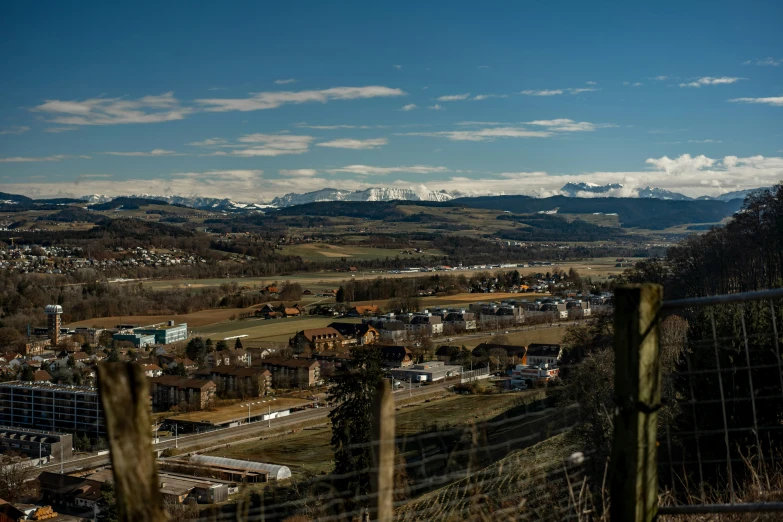 the mountain range is in view from an overlook of a town