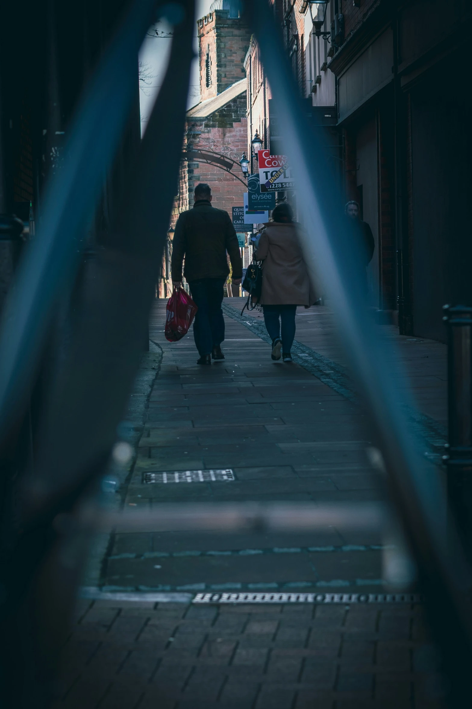 people walking down a sidewalk on a city street