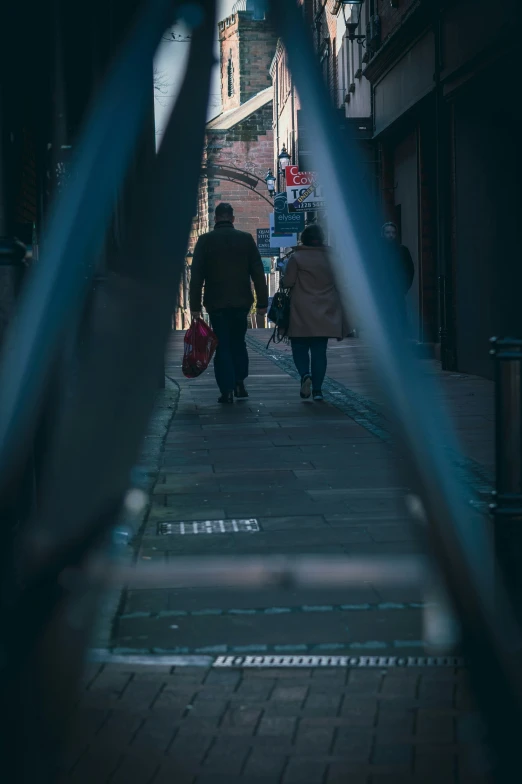 people walking down a sidewalk on a city street