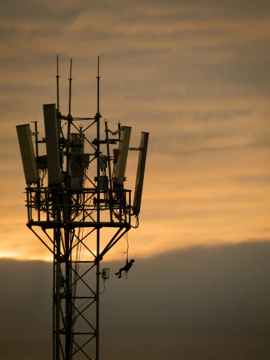 this cellphone tower is near the airport at sunset