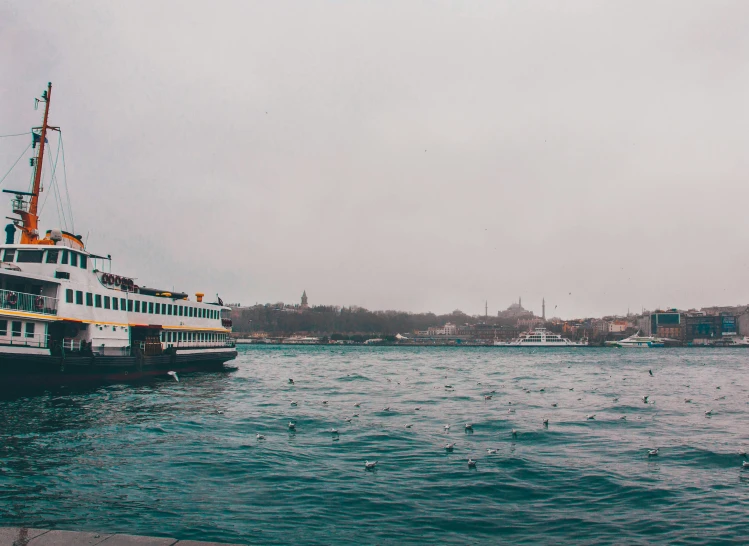 a boat is sailing on the water on a foggy day