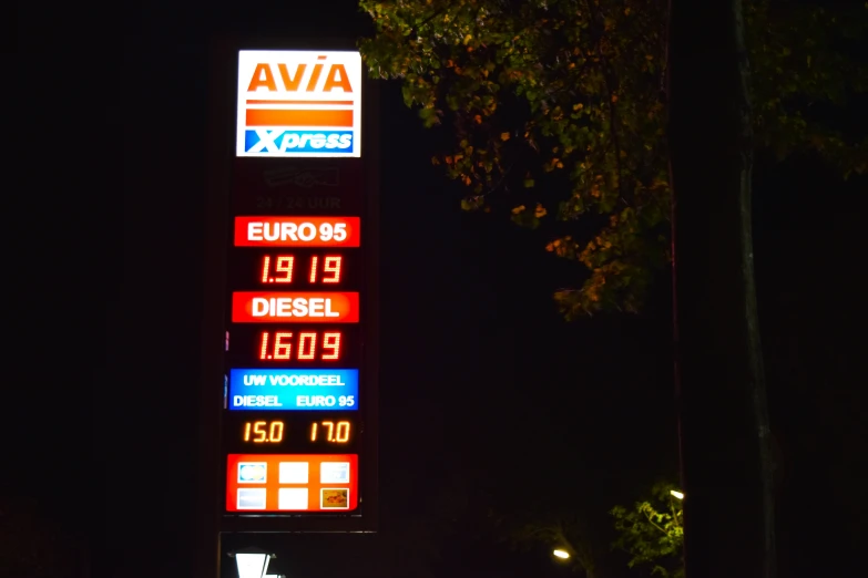 a gas station with many electronic displays on a pole