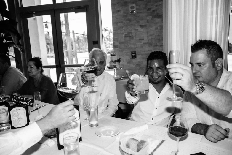 black and white pograph of men drinking together