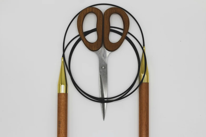 three scissors and wire on a white surface