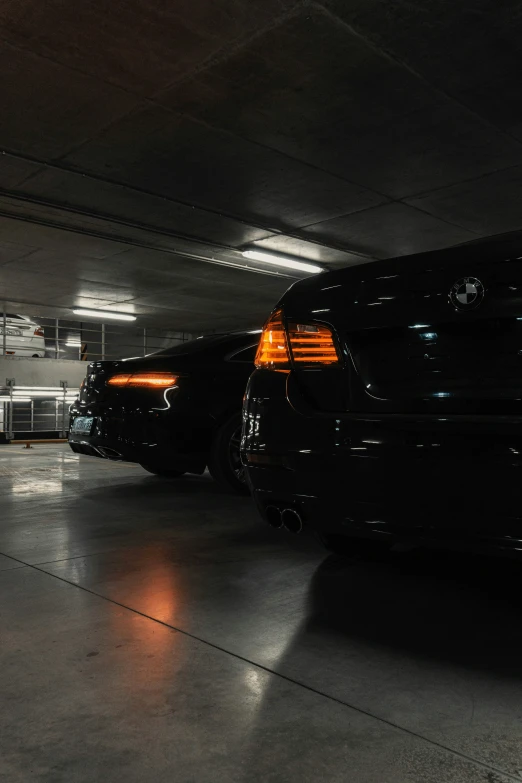 two cars parked side by side in a garage
