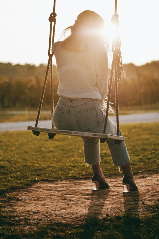 the girl is swinging on the swing