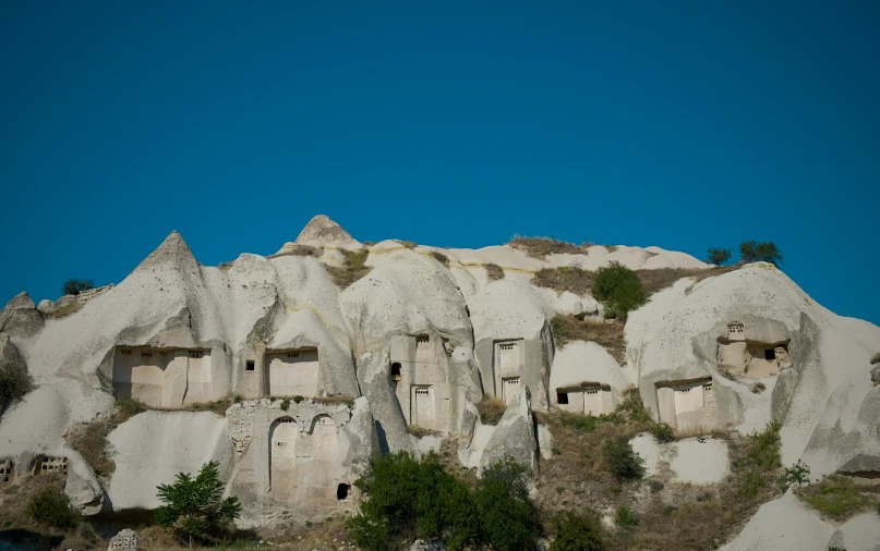 some houses built into the rocky side of a mountain