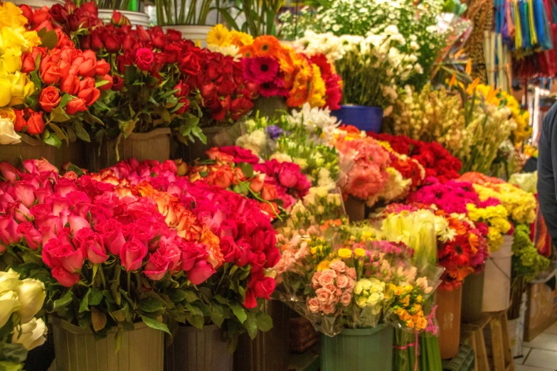 lots of flowers are in old brown vases