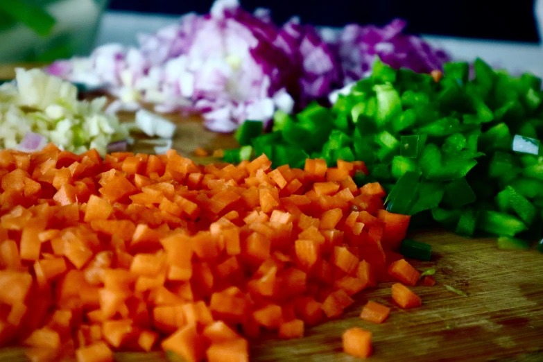 chopped vegetables displayed on wooden surface with knife