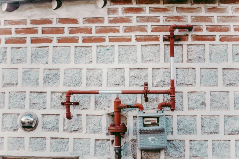 a building with pipes and a phone on it