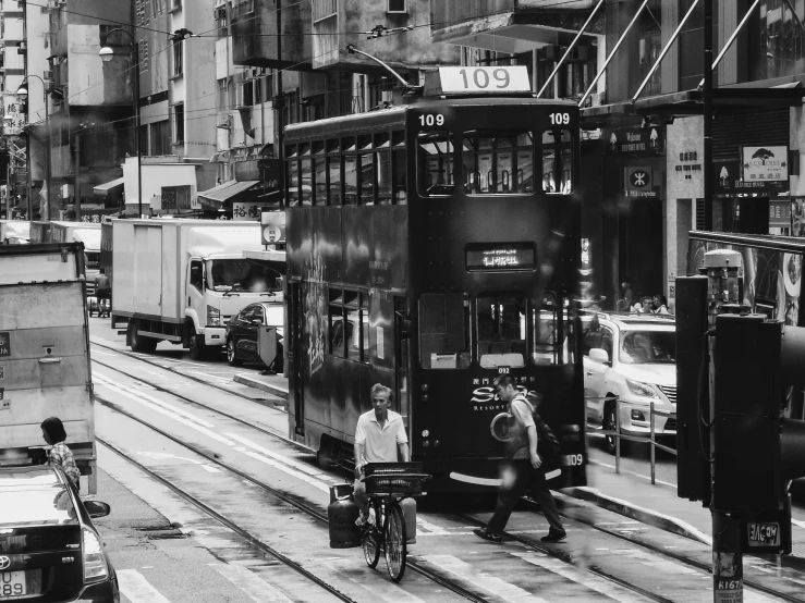 black and white po of trolleys coming down the street