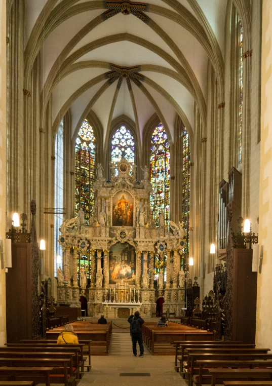 a church with stained glass and wood pews