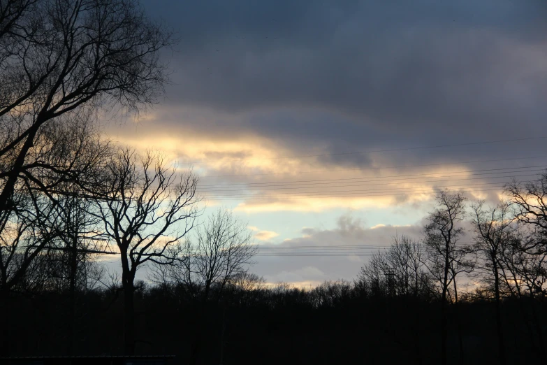 a sunset and several telephone wires in the distance