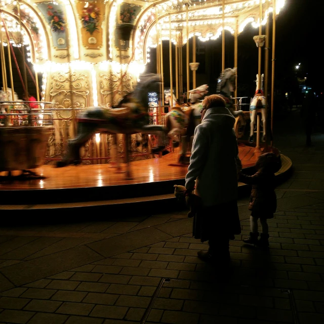 people are on the carousel at night