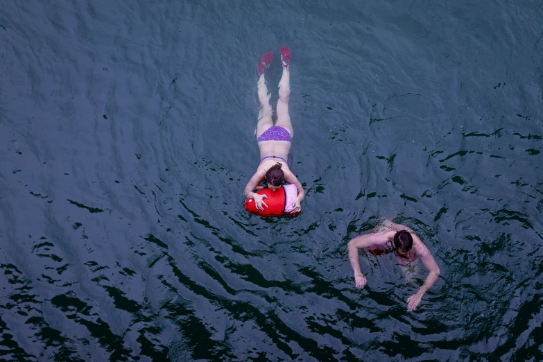 people in the water are swimming together