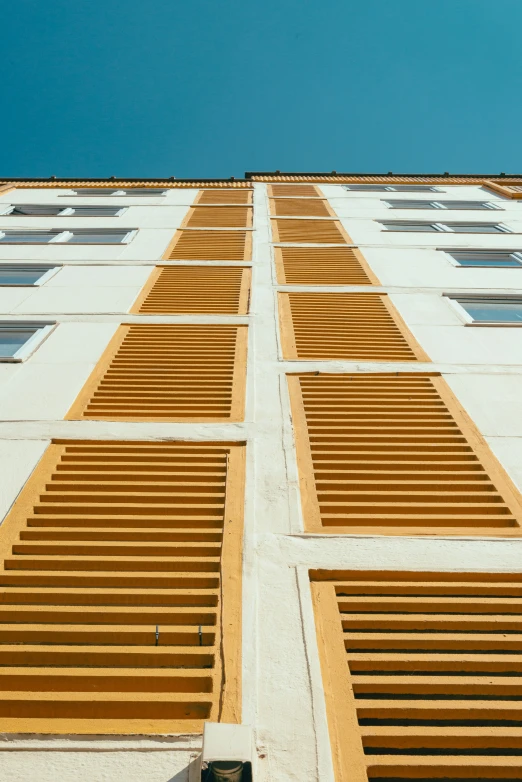 an air plane flying above a building with shutters