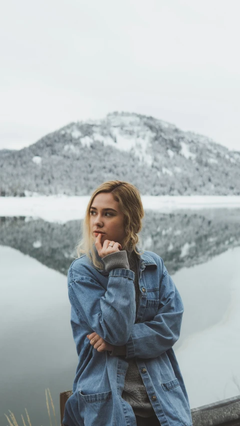 a girl standing next to a body of water