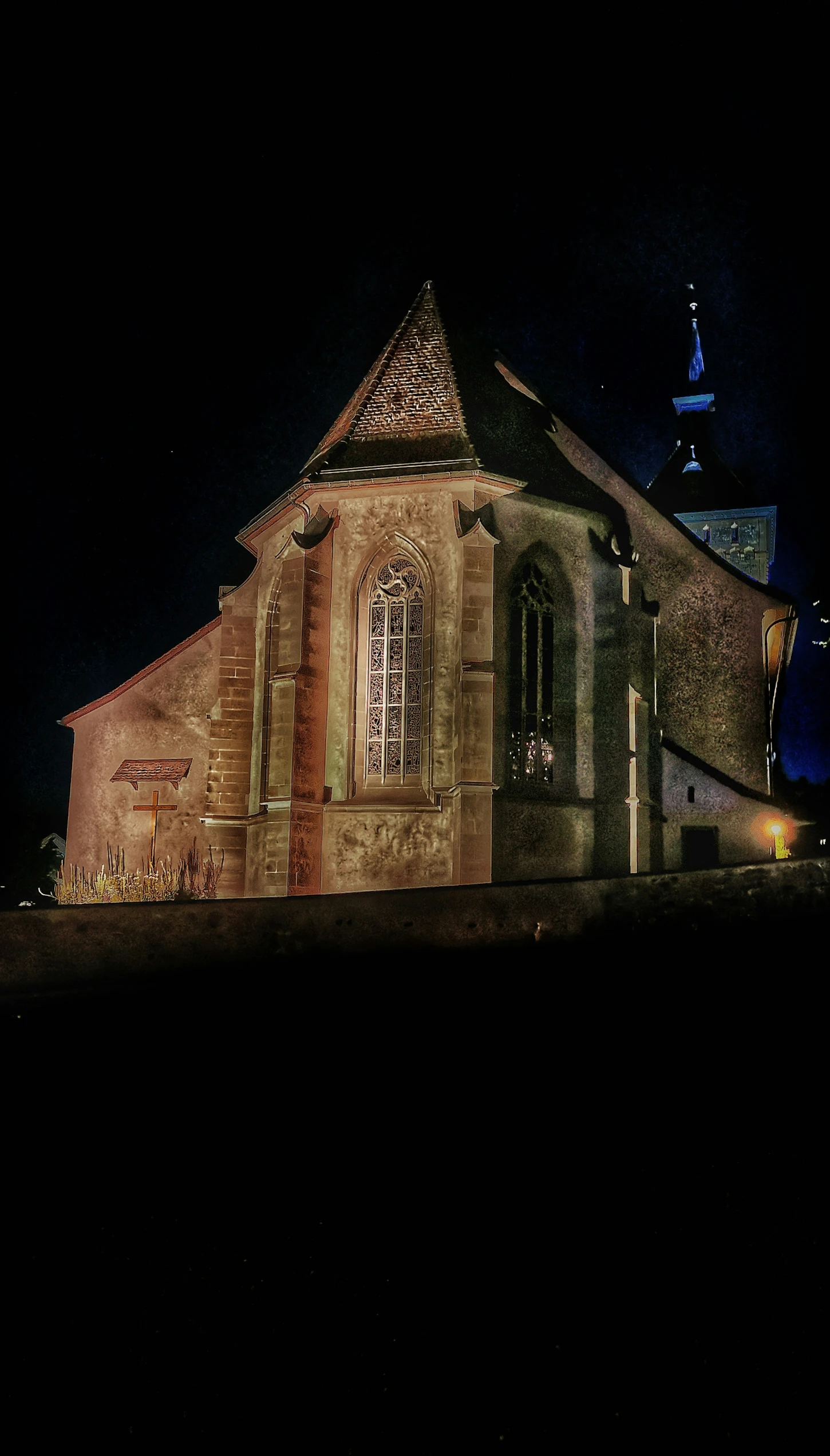 the side of a church that has been illuminated at night