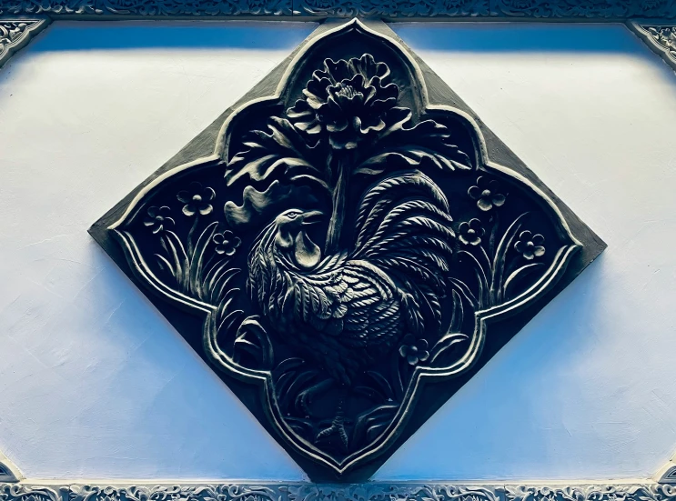 an ornate wall decoration featuring a chicken
