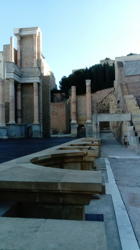 a bunch of concrete benches by some stone stairs