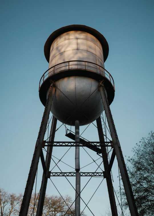 a metal water tower is standing tall with no one on it