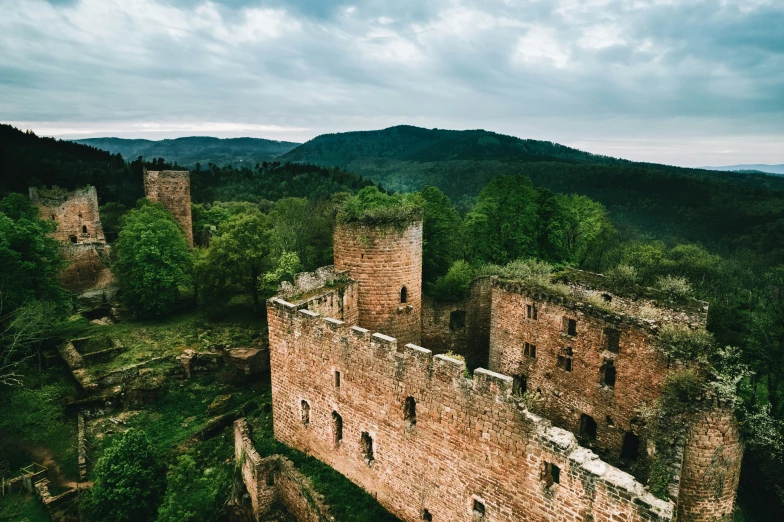 an old stone castle sitting on top of a mountain