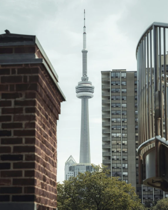 a clock tower standing above buildings near each other