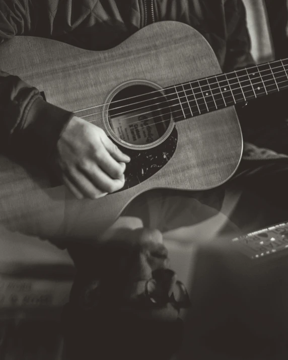 a person playing the guitar in black and white