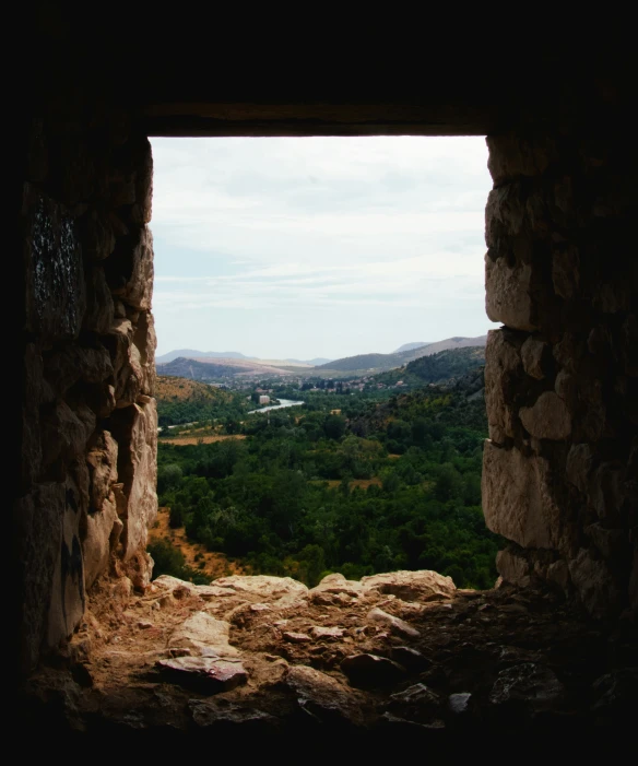 a window that looks out over a mountain range