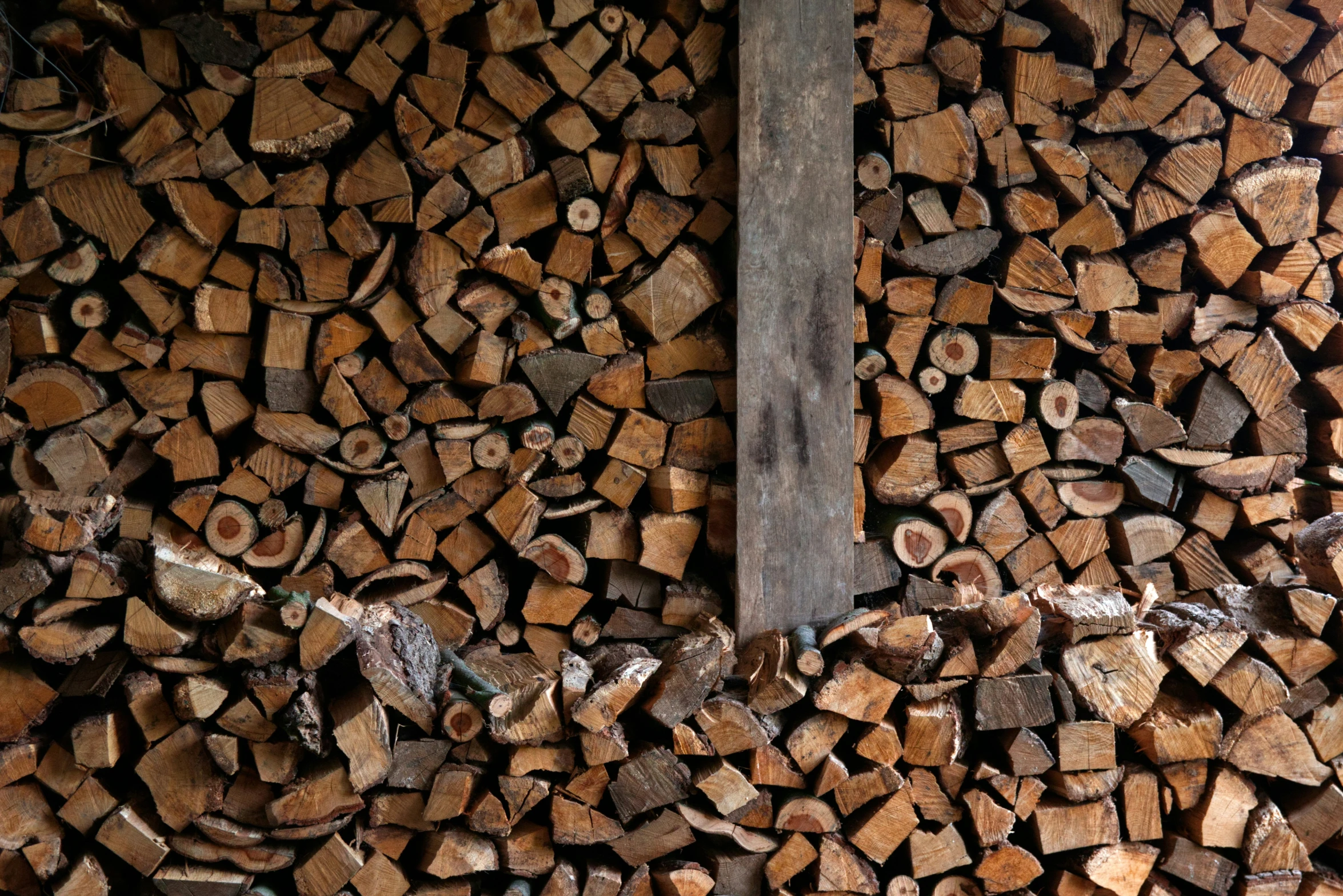 a pile of cut fire wood piled up on top of each other