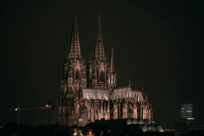 large dark gothic - styled building lit up at night