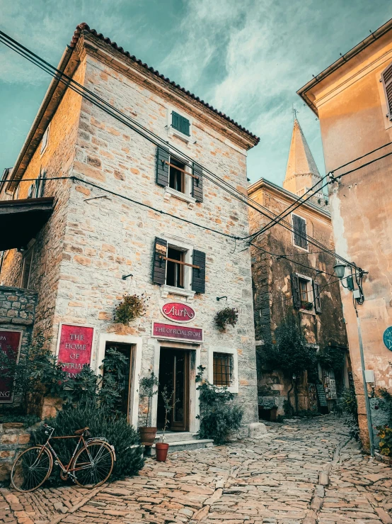 an old brick building with a bicycle in the courtyard