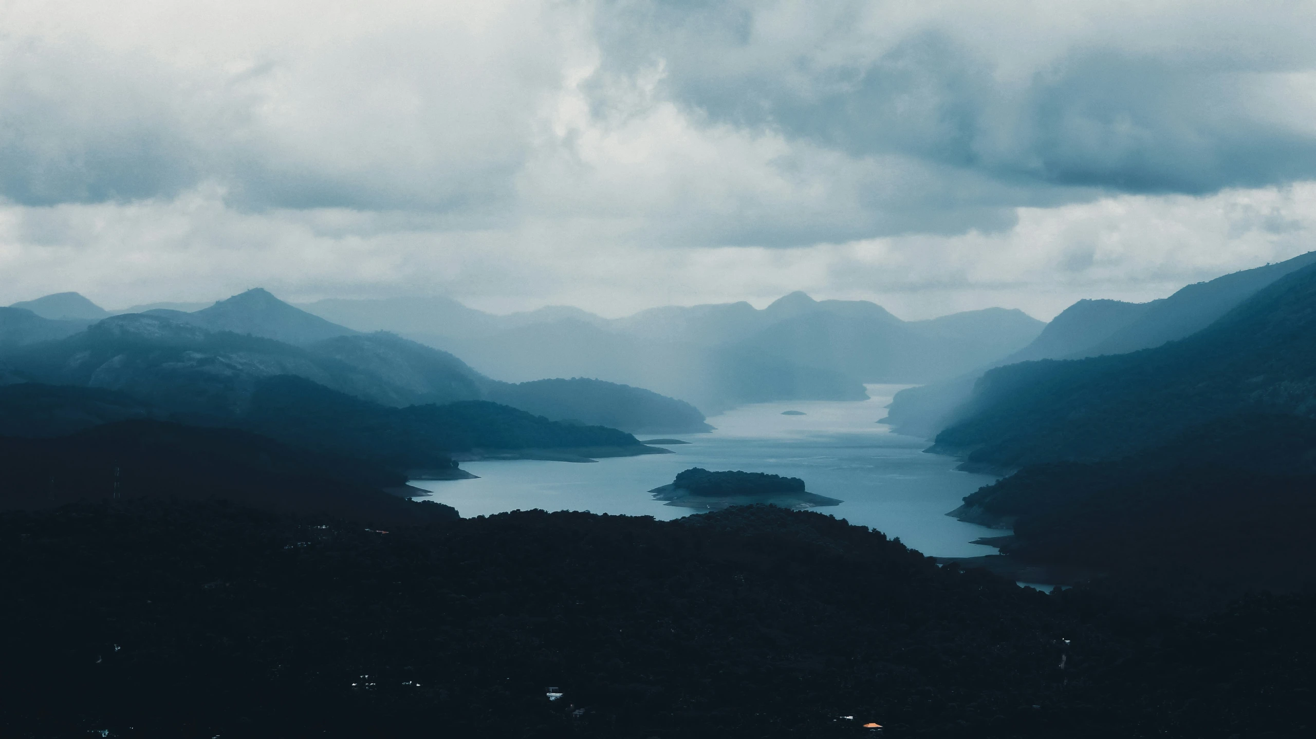 the view of several mountains and water in the daytime