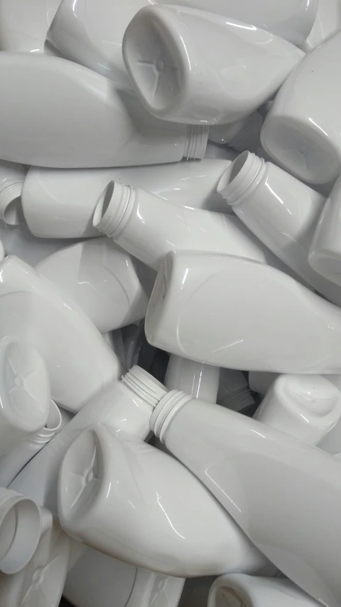large amount of white jugs piled together