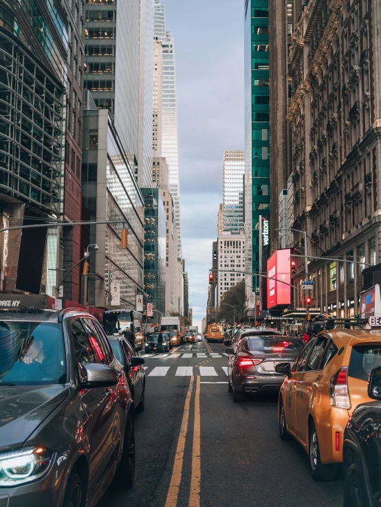 cars on the street during the day with skyscrs and traffic