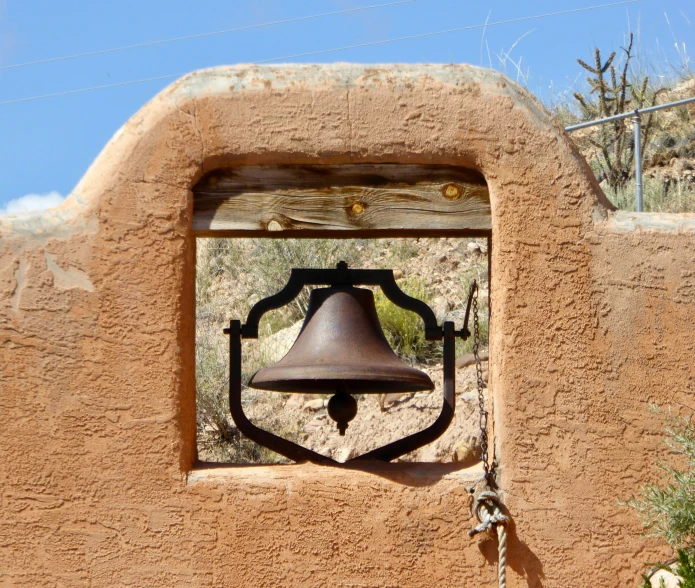 the bell hangs from the side of the wall