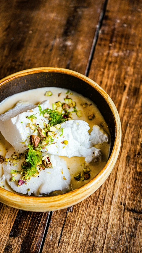 there is soup on the table in a bowl